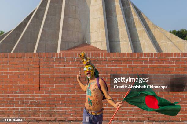 Akash ‘Tiger’ Majumdar, a mascot for the Bangladesh Cricket Board, poses for a photo in front of the Jatiyo Sriti Shoudho to mark the nation's...