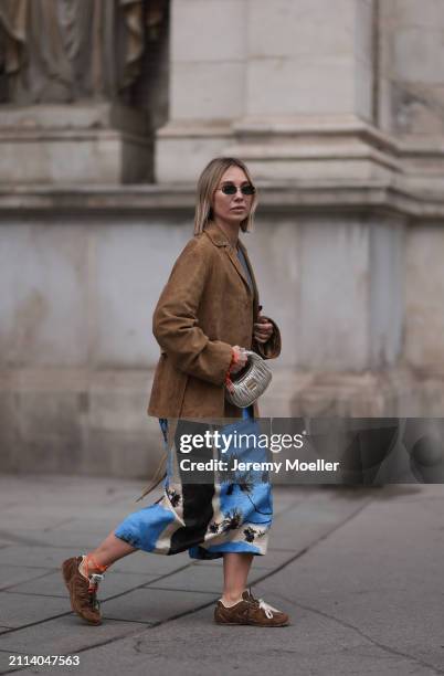 Karin Teigl seen wearing Fendi gold oval sunglasses, Michael Kors grey cotton body top, Zara blue / white / black print pattern midi long skirt, Miu...