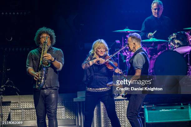 Jake Clemons, Soozie Tyrell, Bruce Springsteen, and Max Weinberg of Bruce Springsteen and the E Street Band perform on stage at Pechanga Arena on...