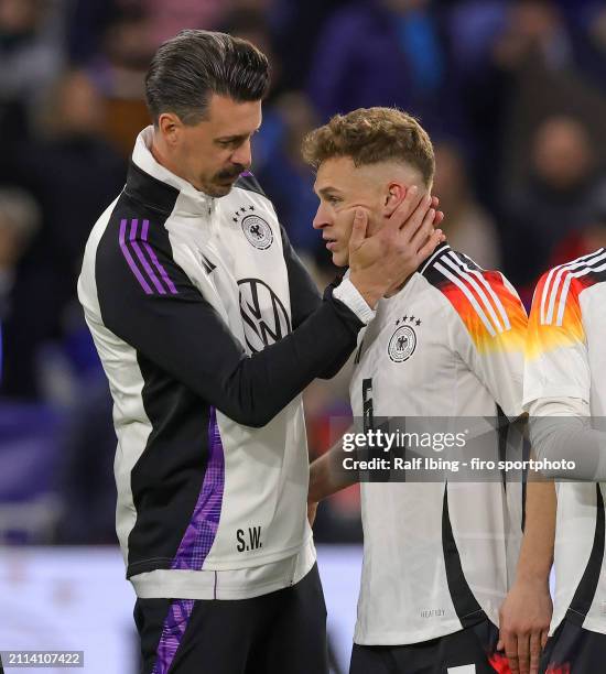 Assistant coach Sandro Wagner of Germany and Joshua Kimmich of Germany look on after the international friendly match between France and Germany at...