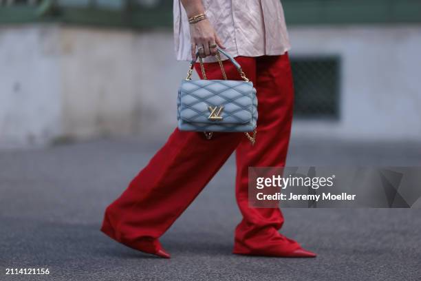 Karin Teigl seen wearing Zara light pink silk long suit vest, Zara red silk long wide leg pants, Louis Vuitton Go 14 baby blue leather bag, Zara red...