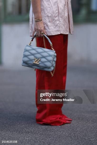 Karin Teigl seen wearing Zara light pink silk long suit vest, Zara red silk long wide leg pants, Louis Vuitton Go 14 baby blue leather bag, Zara red...