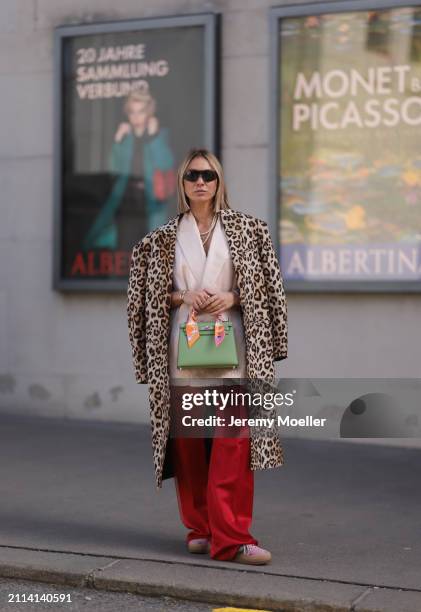 Karin Teigl seen wearing Zara light pink silk long suit vest, Zara red silk long wide leg pants, H&M Studios leopard print pattern long coat, Hermès...
