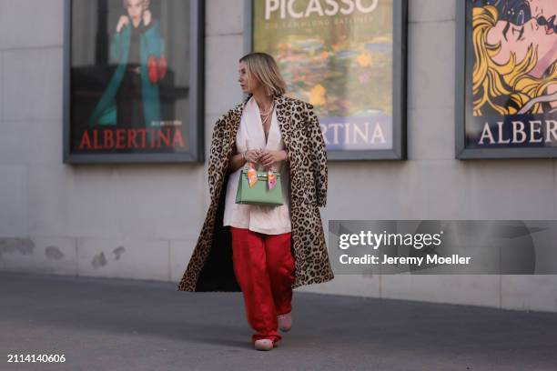 Karin Teigl seen wearing Zara light pink silk long suit vest, Zara red silk long wide leg pants, H&M Studios leopard print pattern long coat, Hermès...