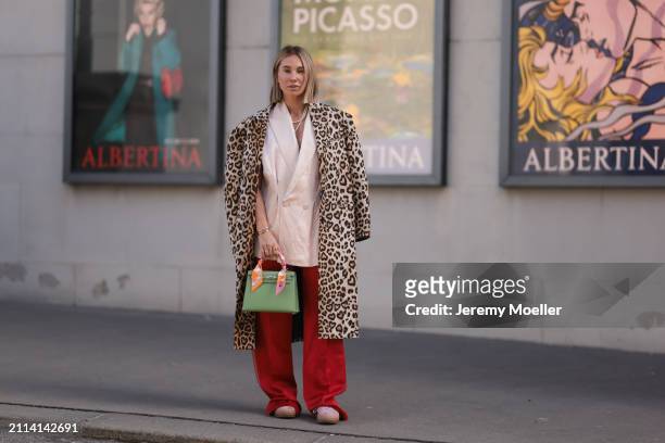 Karin Teigl seen wearing Zara light pink silk long suit vest, Zara red silk long wide leg pants, H&M Studios leopard print pattern long coat, Hermès...