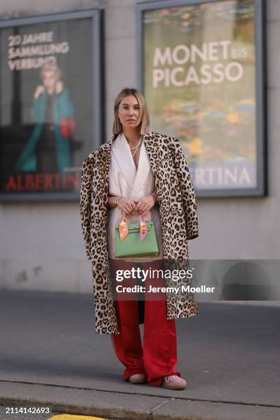 Karin Teigl seen wearing Zara light pink silk long suit vest, Zara red silk long wide leg pants, H&M Studios leopard print pattern long coat, Hermès...