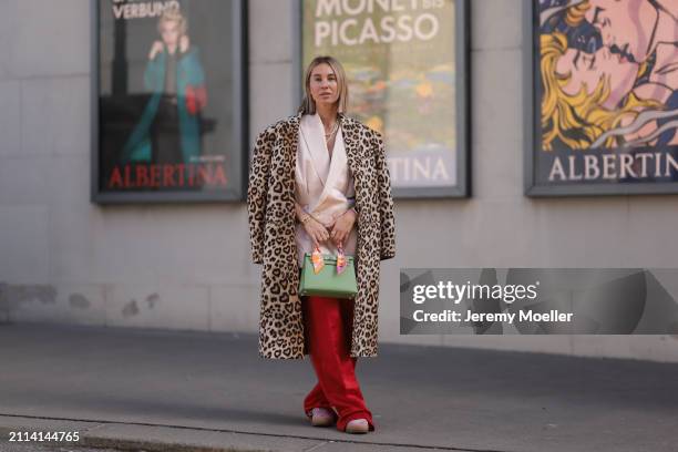 Karin Teigl seen wearing Zara light pink silk long suit vest, Zara red silk long wide leg pants, H&M Studios leopard print pattern long coat, Hermès...