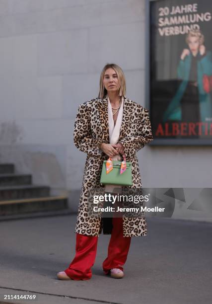 Karin Teigl seen wearing Zara light pink silk long suit vest, Zara red silk long wide leg pants, H&M Studios leopard print pattern long coat, Hermès...