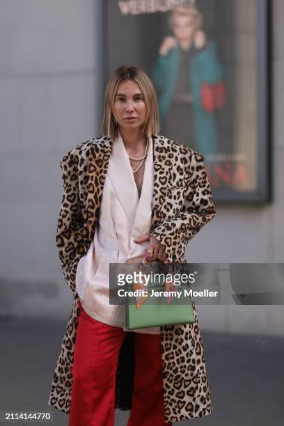 Karin Teigl seen wearing Chanel pearl necklace, Zara light pink silk long suit vest, Zara red silk long wide leg pants, H&M Studios leopard print...