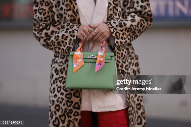 Karin Teigl seen wearing Zara light pink silk long suit vest, Zara red silk long wide leg pants, H&M Studios leopard print pattern long coat, Hermès...