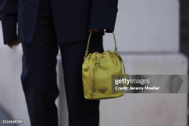 Karin Teigl seen wearing Prada navy blue elegant oversized suit blazer, matching Prada navy blue suit pants and Prada Re-edition lime green nylon...