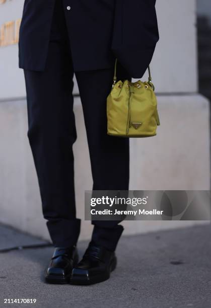 Karin Teigl seen wearing Prada navy blue elegant oversized suit blazer, matching Prada navy blue suit pants, Prada Re-edition lime green nylon mini...