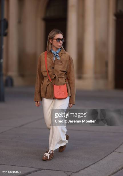 Karin Teigl seen wearing Jacques Marie Mage brown sunglasses with blue lenses, Falconeri blue print pattern small scarf, Miu Miu brown suede leather...