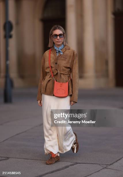 Karin Teigl seen wearing Jacques Marie Mage brown sunglasses with blue lenses, Falconeri blue print pattern small scarf, Miu Miu brown suede leather...