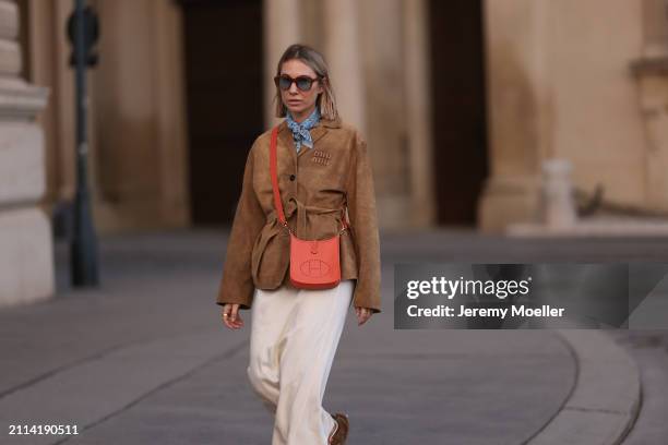 Karin Teigl seen wearing Jacques Marie Mage brown sunglasses with blue lenses, Falconeri blue print pattern small scarf, Miu Miu brown suede leather...