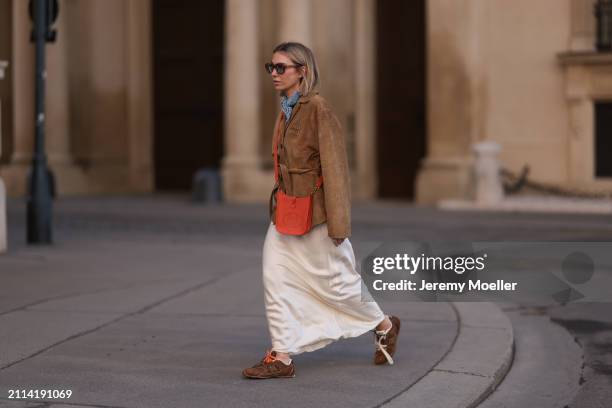 Karin Teigl seen wearing Jacques Marie Mage brown sunglasses with blue lenses, Falconeri blue print pattern small scarf, Miu Miu brown suede leather...