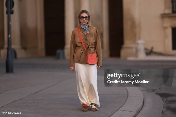 Karin Teigl seen wearing Jacques Marie Mage brown sunglasses with blue lenses, Falconeri blue print pattern small scarf, Miu Miu brown suede leather...