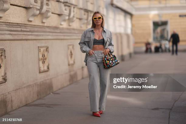 Karin Teigl seen wearing Loewe yellow sunglasses, gold necklaces, Milk White denim grey bral top, Agolde light grey denim buttoned jeans shirt,...