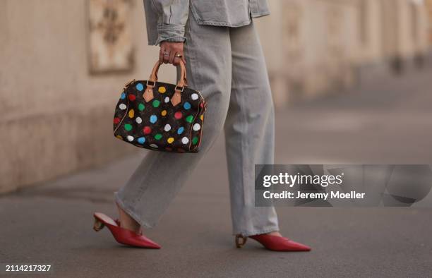 Karin Teigl seen wearing Agolde light grey denim buttoned jeans shirt, matching Agolde light grey denim straight leg pants, Louis Vuitton x Yayoi...