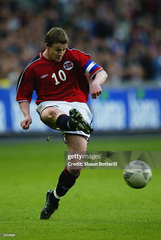 Ole Gunnar Solskjaer of Norway strikes the ball