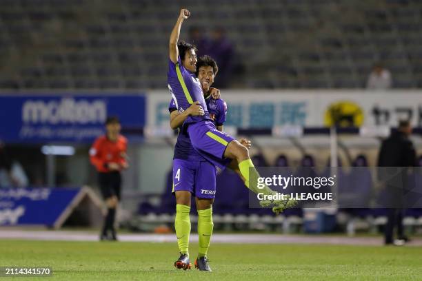 Yoshifumi Kashiwa of Sanfrecce Hiroshima celebrates with teammate Hiroki Mizumoto after scoring the team's second goal during the J.League J1 match...