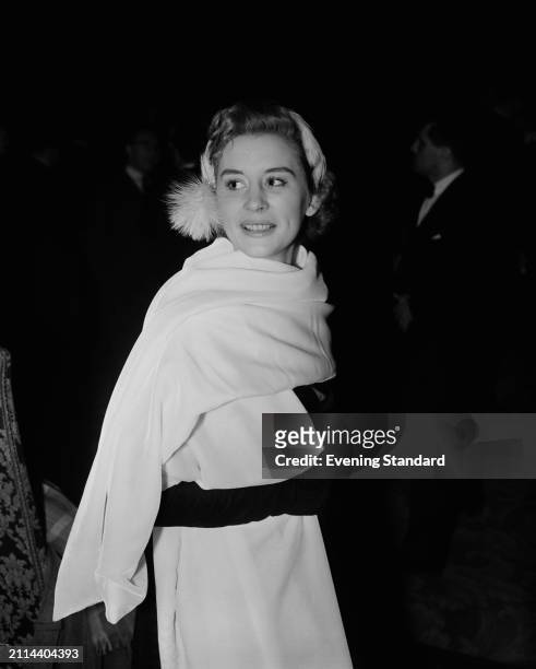 British actress Naomi Chance wearing a white shawl and a tasseled hat, February 9th 1954.