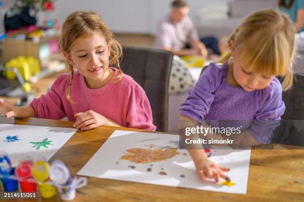 girls painting with watercolours - finger painting stock pictures, royalty-free photos & images