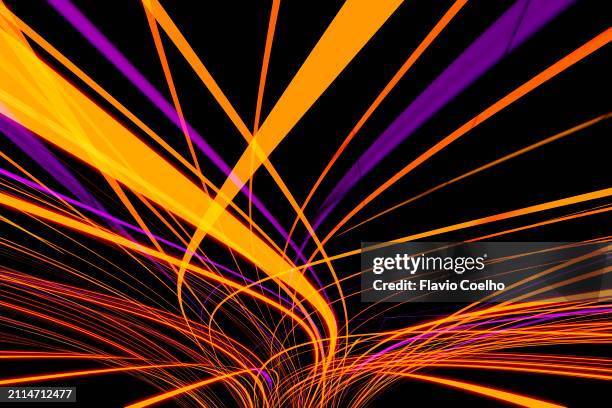 yellow and purple curved light trails - yellow light effect stock pictures, royalty-free photos & images