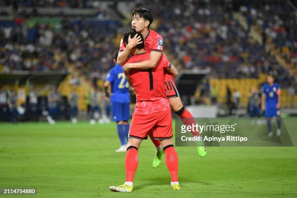 Son Heung-min of South Korea celebrates with teammate Lee Kang-in after scoring the team's second goal during the FIFA World Cup Asian second...