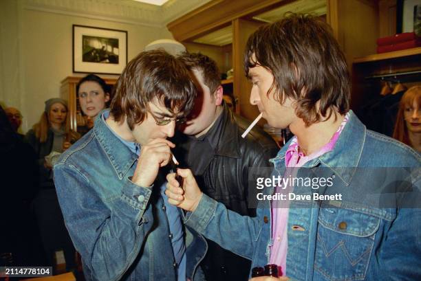 English singer/songwriters Liam Gallagher and Noel Gallagher attend a party for the opening of the Tommy Hilfiger store on New Bond Street, London,...