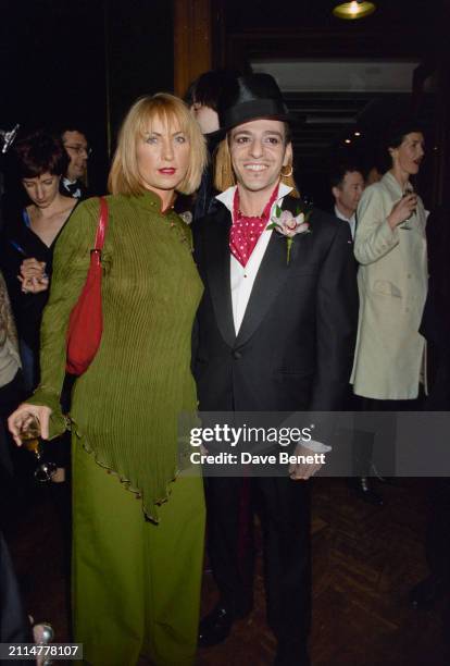 Meg Mathews and British fashion designer John Galliano attend a 'Fashion of The Oscars' party, hosted by US Vogue, at Christies in London, 22nd...