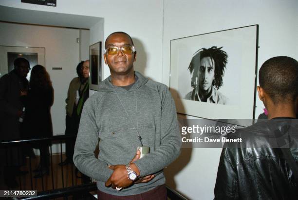 British photographer Dennis Morris posed in front of his portrait of Bob Marley at the 'Bob Marley, Rebel' exhibition at Proud Gallery, London, March...
