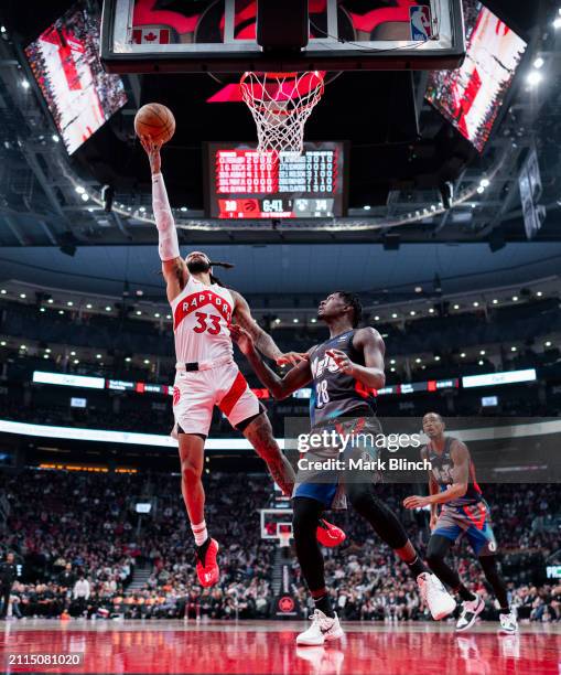 Gary Trent Jr. #33 of the Toronto Raptors goes to the basket against Dorian Finney-Smith of the Brooklyn Nets during the first half of their...