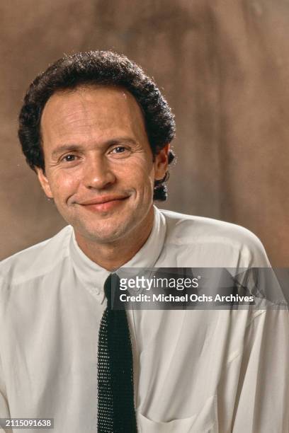 American comedian and actor Billy Crystal, wearing a white button-down shirt and a black tie, poses during a studio portrait session for HBO's Comic...