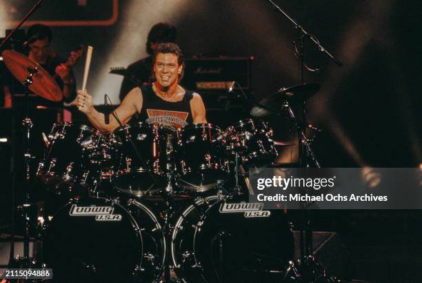 American comedian and actor Joe Piscopo playing the drums, behind a drum kit on stage during 'The Joe Piscopo Halloween Party', recorded at Royce...