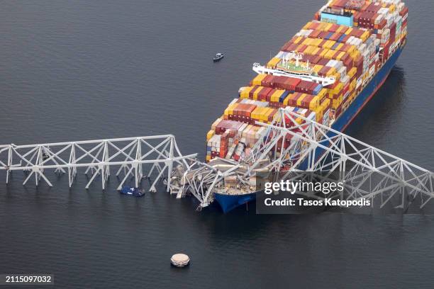 In an aerial view, the cargo ship Dali sits in the water after running into and collapsing the Francis Scott Key Bridge on March 26, 2024 in...