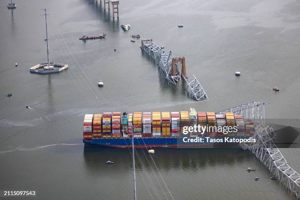 In an aerial view, the cargo ship Dali sits in the water after running into and collapsing the Francis Scott Key Bridge on March 26, 2024 in...