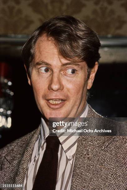 American actor and singer Troy Donahue, wearing a herringbone jacket over a white-and-black striped shirt with a black tie, United States, circa 1985.