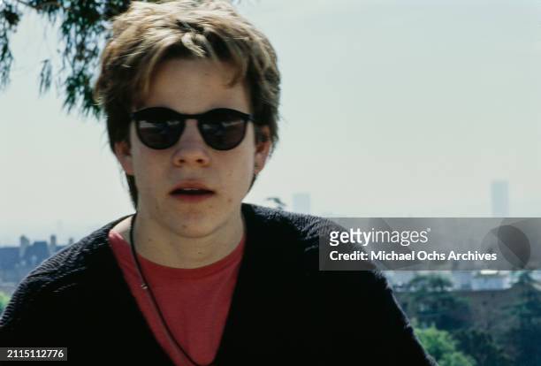 American actor Stephen Dorff, wearing a black v-neck sweater over a red t-shirt with a bootlace necklace and sunglasses, during a portrait session,...