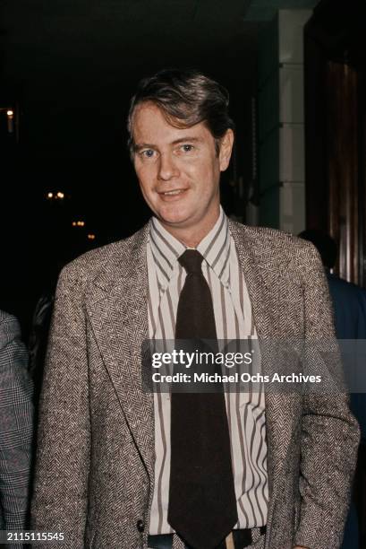 American actor and singer Troy Donahue, wearing a herringbone jacket over a white-and-black striped shirt with a black tie, United States, circa 1985.