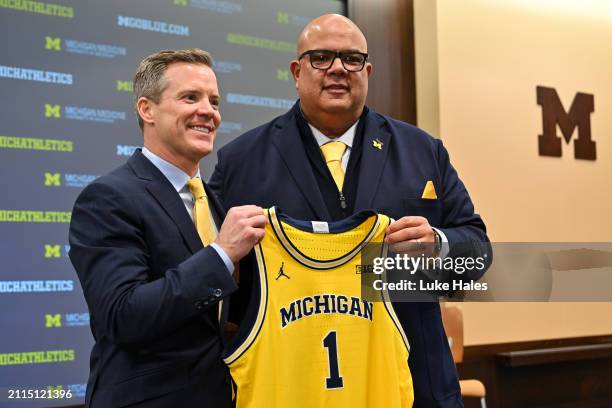 Newly appointed head men's basketball coach Dusty May of the University of Michigan poses for a photo with Athletic Director Warde Manuel during a...