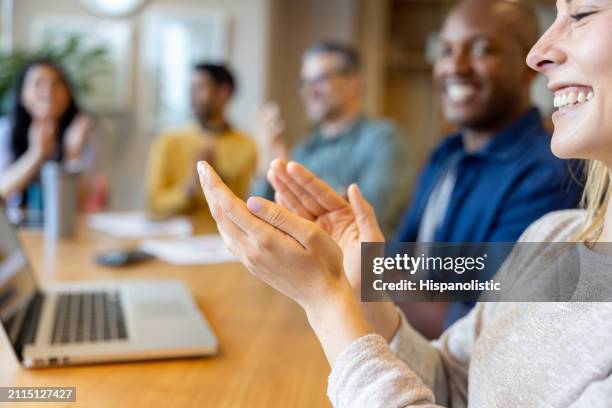 business people applauding in a successful meeting at the office - hispanolistic stock pictures, royalty-free photos & images