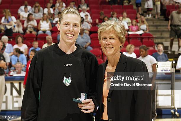 Katie Smith of the Minnesota Lynx accepts a ring honoring her assistance in the 2002 World Championships from USA Basketball assistant executive...