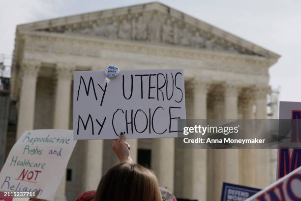 Demonstrators participate in a abortion-rights rally outside the Supreme Court as the justices of the court hear oral arguments in the case of the...