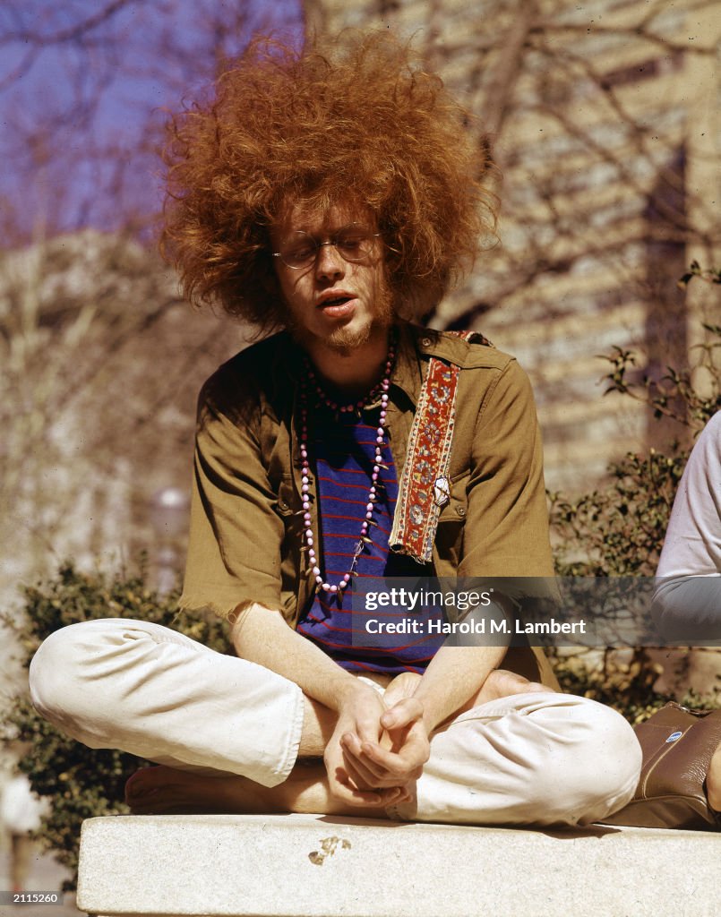 hippie-sitting-cross-legged-outdoors.jpg
