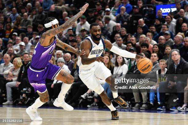 Tim Hardaway Jr. #10 of the Dallas Mavericks drives around Jordan Clarkson of the Utah Jazz during the second half of a game at Delta Center on March...