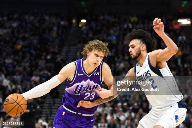 Lauri Markkanen of the Utah Jazz drives into Dereck Lively II of the Dallas Mavericks during the first half of a game at Delta Center on March 25,...