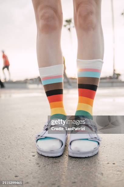 person wearing rainbow socks during the pride month - sandálias com meias imagens e fotografias de stock
