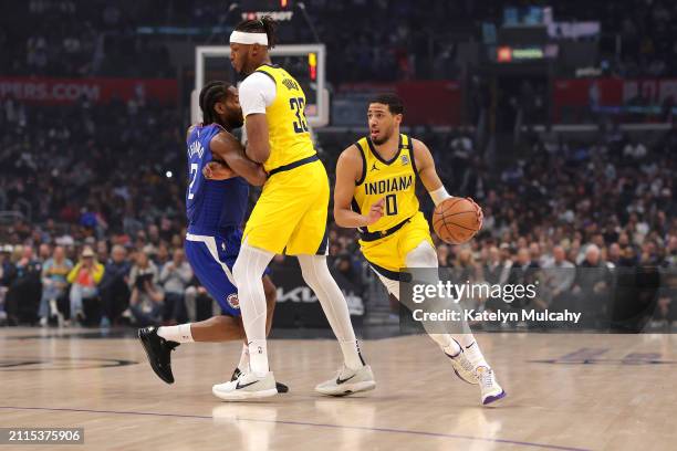 Tyrese Haliburton of the Indiana Pacers drives past Kawhi Leonard of the Los Angeles Clippers during the first quarter at Crypto.com Arena on March...