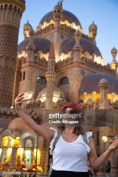 woman taking a selfie in front of al sahaba mosque, (el mustafa mosque) in sharm el sheikh, egypt - sinai egypt stock pictures, royalty-free photos & images